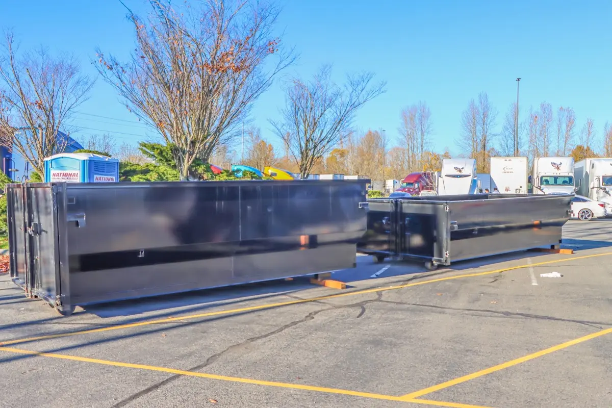 Professional dumpster rental service with roll-off container on residential driveway in Centerton